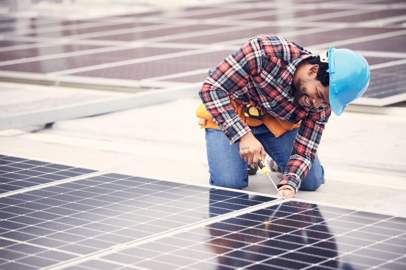 Technician Securing Solar Panels
